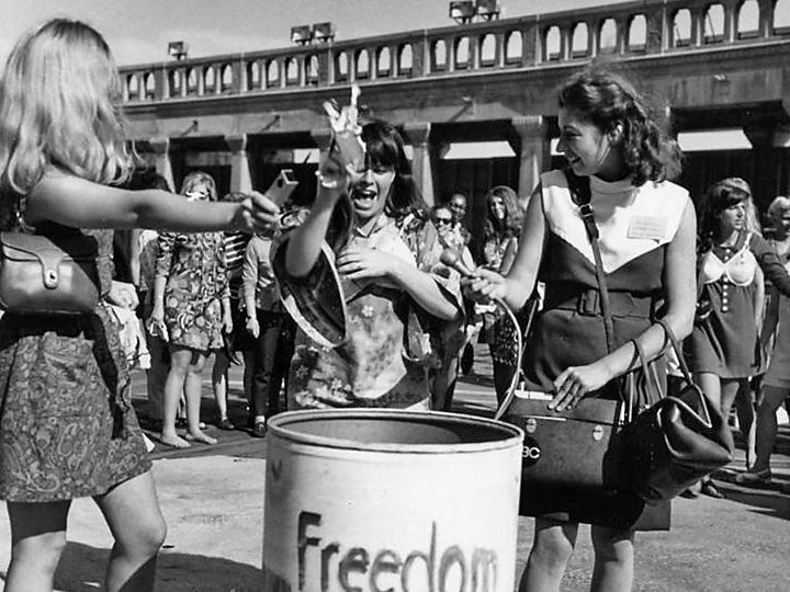 Demonstrators toss symbols of sexism into the “Freedom Trash Can”