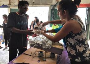 A community-run kitchen serves food in Caguas