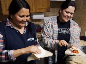Ginny Calderon (right) and Ceci Mejia prepare tamales for striking teachers in Denver